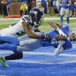 Detroit Lions wide receiver Josh Reynolds, defended by Seattle Seahawks cornerback Mike Jackson catches a 3-yard pass for a touchdown during the second half of an NFL football game, Sunday, Oct. 2, 2022, in Detroit. (AP Photo/Duane Burleson)