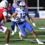 
              BYU's Puka Nacua makes a run up field to score a touchdown against Liberty during an NCAA college football game, Saturday, Oct. 22, 2022, in Lynchburg, Va. (Paige Dingler/The News & Advance via AP)
            