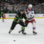 Dallas Stars center Luke Glendening (11) and New York Rangers right wing Vitali Kravtsov (74) battle for the puck during the first period of an NHL hockey game in Dallas, Saturday, Oct. 29, 2022. (AP Photo/Michael Ainsworth)
