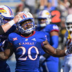
              Kansas running back Daniel Hishaw Jr. (20) celebrates with teammate offensive lineman Mike Novitsky (50) after scoring a touchdown against Iowa State during the first half of an NCAA college football game, Saturday, Oct. 1, 2022, in Lawrence, Kan. (AP Photo/Reed Hoffmann)
            
