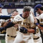 Milwaukee Brewers' Hunter Renfroe is congratulated after hitting a walk-off single during the 10th inning of a baseball game against the Arizona Diamondbacks Monday, Oct. 3, 2022, in Milwaukee. The Brewers won 6-5. (AP Photo/Morry Gash)