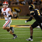 Georgia quarterback Stetson Bennett (13) scrambles as Missouri defensive back Martez Manuel (3) defends during the first half of an NCAA college football game Saturday, Oct. 1, 2022, in Columbia, Mo. (AP Photo/L.G. Patterson)
