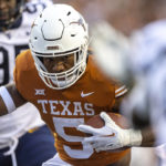 
              Texas running back Bijan Robinson (5) carries against West Virginia during the first half of an NCAA college football game Saturday, Oct. 1, 2022, in Austin, Texas. (AP Photo/Stephen Spillman)
            