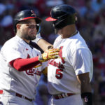 
              St. Louis Cardinals' Albert Pujols gets a hug from teammate Yadier Molina, left, after hitting a solo home run during the third inning of a baseball game against the Pittsburgh Pirates Sunday, Oct. 2, 2022, in St. Louis. (AP Photo/Jeff Roberson)
            