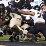 
              Wake Forest running back Justice Ellison, left, runs into the end zone for a touchdown against Army during the first half of an NCAA college football game in Winston-Salem, N.C., Saturday, Oct. 8, 2022. (AP Photo/Chuck Burton)
            