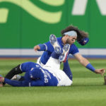 
              Toronto Blue Jays shortstop Bo Bichette, rear, and center fielder George Springer collide while to trying to catch a short fly ball by Seattle Mariners J.P. Crawford during the eighth inning of Game 2 of a baseball AL wild-card playoff series Saturday, Oct. 8, 2022, in Toronto. Springer left the game. (Frank Gunn/The Canadian Press via AP)
            