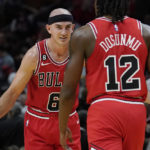 Chicago Bulls guard Alex Caruso (6) congratulates guard Ayo Dosunmu (12) after scoring during the first half of an NBA game Wednesday, Oct. 19, 2022, in Miami. (AP Photo/Marta Lavandier)
