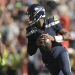 Seattle Seahawks quarterback Geno Smith (7) drops back to pass against the Arizona Cardinals during the first half of an NFL football game in Seattle, Sunday, Oct. 16, 2022. (AP Photo/Caean Couto)