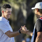 
              Rory McIlroy, left, of Northern Ireland, left, celebrates with his caddie after the final round of the CJ Cup golf tournament Sunday, Oct. 23, 2022, in Ridgeland, S.C. (AP Photo/Stephen B. Morton)
            