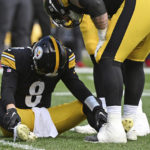Pittsburgh Steelers quarterback Kenny Pickett (8) is helped on the field after being injured during the second half of an NFL football game against the Tampa Bay Buccaneers in Pittsburgh, Sunday, Oct. 16, 2022. (AP Photo/Barry Reeger)