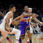 Phoenix Suns guard Chris Paul (3) dishes off against the New Orleans Pelicans during the second half of an NBA basketball game, Friday, Oct. 28, 2022, in Phoenix. (AP Photo/Matt York)