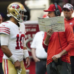 San Francisco 49ers head coach Kyle Shanahan speaks with San Francisco 49ers quarterback Jimmy Garoppolo (10) during the first half of an NFL football game, Sunday, Oct. 16, 2022, in Atlanta. (AP Photo/John Bazemore)
