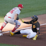 Pittsburgh Pirates' Miguel Andujar, right, beats the tag by St. Louis Cardinals third baseman Juan Yepez with a triple during the fourth inning of a baseball game, Wednesday, Oct. 5, 2022, in Pittsburgh. (AP Photo/Keith Srakocic)