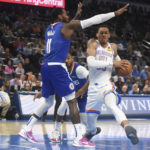 
              Oklahoma City Thunder forward Darius Bazley, right, pushes past Los Angeles Clippers guard John Wall, left, in the first half of an NBA basketball game, Thursday, Oct. 27, 2022, in Oklahoma City. (AP Photo/Kyle Phillips)
            