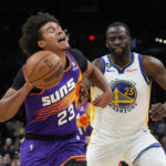 Phoenix Suns forward Cameron Johnson reacts after getting fouled by Golden State Warriors forward Draymond Green (23) during the second half of an NBA basketball game, Tuesday, Oct. 25, 2022, in Phoenix. Phoenix won 134-105. (AP Photo/Rick Scuteri)