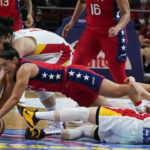 
              United States' Kelsey Plum dives to compete for the ball with China's Li Yueru, top, and Wang Siyu (5) during the gold medal game at the women's Basketball World Cup in Sydney, Australia, Saturday, Oct. 1, 2022. (AP Photo/Mark Baker)
            