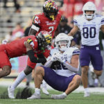 Northwestern running back Evan Hull is tackled by Maryland defensive back Tarheeb Still in the first half of an NCAA college football game, Saturday, Oct. 22, 2022, in College Park, Md. (AP Photo/Gail Burton)