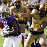 Washington running back Cameron Davis (22) scores a touchdown, beating Arizona State linebacker Merlin Robertson (8) to the end zone, during the second half of an NCAA college football game in Tempe, Ariz., Saturday, Oct. 8, 2022. (AP Photo/Ross D. Franklin)