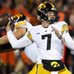 Iowa quarterback Spencer Petras passes during the first half of an NCAA college football game against the Illinois Saturday, Oct. 8, 2022, in Champaign, Ill. (AP Photo/Charles Rex Arbogast)