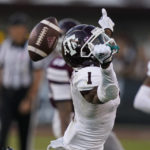 
              Texas A&M wide receiver Evan Stewart (1) looses a pass as Mississippi State cornerback Emmanuel Forbes intercepts it during the second half of an NCAA college football game against Mississippi State in Starkville, Miss., Saturday, Oct. 1, 2022. (AP Photo/Rogelio V. Solis)
            