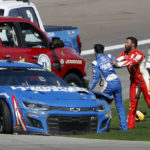 
              Bubba Wallace, center, shoves Kyle Larson (5), left, after they crashed during a NASCAR Cup Series auto race at Las Vegas Motor Speedway in Las Vegas, Sunday, Oct. 16, 2022. (Steve Marcus/Las Vegas Sun via AP)
            