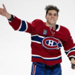 First star of the game, Montreal Canadiens' Juraj Slafkovsky, tosses pucks to the crowd after defeating the Arizona Coyotes in NHL hockey action in Montreal, Thursday, Oct. 20, 2022. (Paul Chiasson/The Canadian Press via AP)