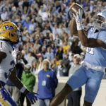 North Carolina wide receiver Josh Downs (11) pulls in a pass for a touchdown against Pittsburgh defensive back Erick Hallett II (31) during the second half of an NCAA college football game in Chapel Hill, N.C., Saturday, Oct. 29, 2022. (AP Photo/Chris Seward)
