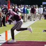 Mississippi State wide receiver Caleb Ducking reaches for a four-yard touchdown pass reception while Texas A&M defensive back Denver Harris (2) pursues during the first half of an NCAA college football game in Starkville, Miss., Saturday, Oct. 1, 2022. (AP Photo/Rogelio V. Solis)