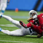 Arizona Cardinals safety Jalen Thompson is tackled by Carolina Panthers wide receiver DJ Moore after an interception during the first half of an NFL football game on Sunday, Oct. 2, 2022, in Charlotte, N.C. (AP Photo/Jacob Kupferman)