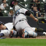 
              Milwaukee Brewers' Luis Urias, left, is tagged out at home by Miami Marlins' Jacob Stallings during the 10th inning of a baseball game Sunday, Oct. 2, 2022, in Milwaukee. (AP Photo/Aaron Gash)
            