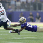 Arizona wide receiver Jacob Cowing catches a pass with Washington cornerback Mishael Powell diving during the first half on an NCAA football game, Saturday, Oct. 15, 2022, in Seattle. (AP Photo/John Froschauer)