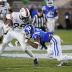 
              Virginia's Keytaon Thompson (99) is hit by Duke's Darius Joiner (1) during the second half of an NCAA college football game in Durham, N.C., Saturday, Oct. 1, 2022. (AP Photo/Ben McKeown)
            