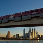 
              FILE - A monorail on the Palm Jumeirah passes on a track above the skyline of the Dubai Marina in Dubai, United Arab Emirates, on Dec. 21, 2019. The FIFA World Cup may be bringing as many as 1.2 million fans to Qatar, but the nearby flashy emirate of Dubai is also looking to cash in on the major sports tournament taking place just a short flight away. (AP Photo/Jon Gambrell, File)
            