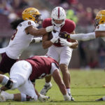 Stanford fullback Shield Taylor, center, runs against Arizona State linebackers Merlin Robertson, left, and Kyle Soelle, right, during the first half of an NCAA college football game in Stanford, Calif., Saturday, Oct. 22, 2022. (AP Photo/Jeff Chiu)
