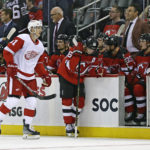 
              Detroit Red Wings left wing Dominik Kubalik skates past the New Jersey Devils bench after scoring a goal in the third period of an NHL hockey game Saturday, Oct. 15, 2022, in Newark, N.J. The Red Wings won 5-2. (AP Photo/Adam Hunger)
            