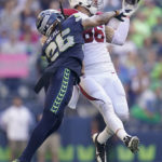 Seattle Seahawks safety Ryan Neal, left, breaks up a pass intended for Arizona Cardinals tight end Zach Ertz during the second half of an NFL football game in Seattle, Sunday, Oct. 16, 2022. (AP Photo/Abbie Parr)