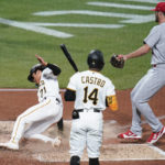 
              Pittsburgh Pirates' Ji Hwan Bae (71) scores next to Rodolfo Castro (14) on a wild pitch by St. Louis Cardinals' Dakota Hudson (43) during the third inning of a baseball game Tuesday, Oct. 4, 2022, in Pittsburgh. (AP Photo/Keith Srakocic)
            