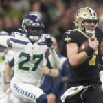 New Orleans Saints' Taysom Hill heads to the end zone for a 60 yard rushing touchdown as Seattle Seahawks' Tariq Woolen pursues during an NFL football game in New Orleans, Sunday, Oct. 9, 2022. (AP Photo/Gerald Herbert)