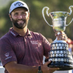
              Jon Rahm, of Spain, holds the trophy after winning the Spanish Open golf tournament at Club de Campo Villa in Madrid, Spain, Sunday, Oct. 9, 2022. (AP Photo/Manu Fernandez)
            