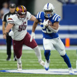 
              Indianapolis Colts running back Jonathan Taylor (28) runs past Washington Commanders defensive end Casey Toohill (95) in the first half of an NFL football game in Indianapolis, Sunday, Oct. 30, 2022. (AP Photo/AJ Mast)
            