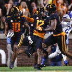 Tennessee linebacker Juwan Mitchell (10) returns an interception during the first half of an NCAA college football game against Kentucky, Saturday, Oct. 29, 2022, in Knoxville, Tenn. (AP Photo/Wade Payne)