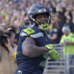 Seattle Seahawks running back Kenneth Walker III celebrates after scoring a touchdown against the Arizona Cardinals during the second half of an NFL football game in Seattle, Sunday, Oct. 16, 2022. (AP Photo/Caean Couto)