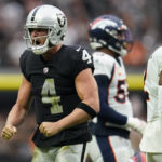 Las Vegas Raiders quarterback Derek Carr (4) celebrates a first down against the Denver Broncos during the first half of an NFL football game, Sunday, Oct. 2, 2022, in Las Vegas. (AP Photo/Abbie Parr)