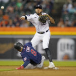 
              Detroit Tigers second baseman Harold Castro throws to first base over Minnesota Twins' Jake Cave for the double play hit into by Twins' Gary Sanchez during the fourth inning of a baseball game, Saturday, Oct. 1, 2022, in Detroit. (AP Photo/Carlos Osorio)
            