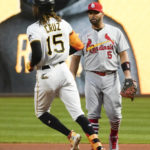Pittsburgh Pirates' Oneil Cruz (15) steps on first next  St. Louis Cardinals first baseman Albert Pujols, after a base hit during the first inning of a baseball game Tuesday, Oct. 4, 2022, in Pittsburgh. (AP Photo/Keith Srakocic)