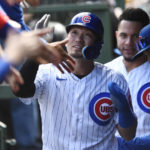 
              Chicago Cubs' Seiya Suzuki, center, celebrates with teammates in the dugout after scoring on a Franmil Reyes single during the first inning of a baseball game against the Cincinnati Reds, Sunday, Oct. 2, 2022, in Chicago. (AP Photo/Paul Beaty)
            