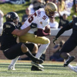 Boston College quarterback Phil Jurkovec (5) is sacked by Wake Forest defensive lineman Rondell Bothroyd, left, during the first half of an NCAA college football game in Winston-Salem, N.C., Saturday, Oct. 22, 2022. (AP Photo/Chuck Burton)