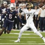 Colorado quarterback Owen McCown (7) throws a pass while being pressured by Arizona safety Christian Young (5) during the first half of an NCAA college football game Saturday, Oct. 1, 2022, in Tucson, Ariz. (AP Photo/Rick Scuteri)