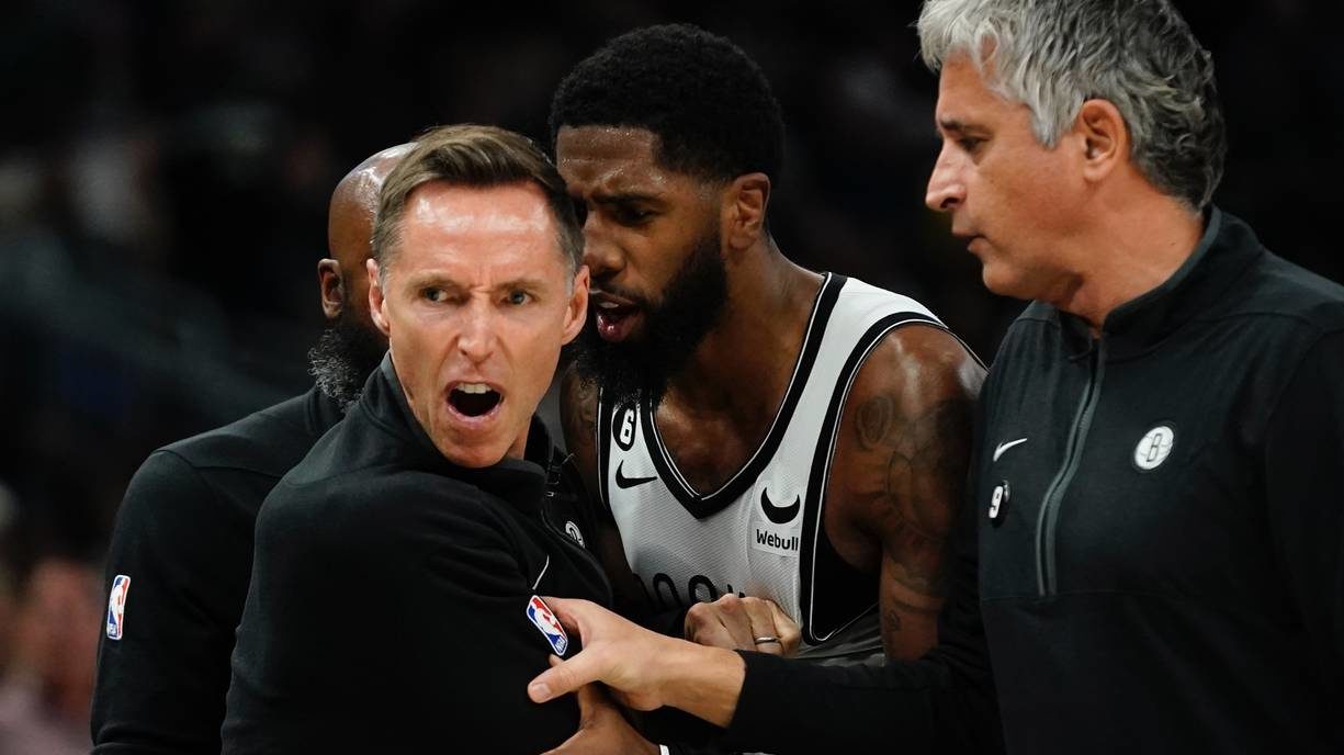 Brooklyn Nets head coach Steve Nash is restrained after having a technical foul called on him durin...