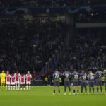 Players observe a minute of silence, in the memory of the fatal victims of a stampede during a soccer match in Indonesia, before the Champions League group A soccer match between Ajax and Napoli at the Johan Cruyff ArenA in Amsterdam, Netherlands, Tuesday, Oct. 4, 2022. (AP Photo/Peter Dejong)